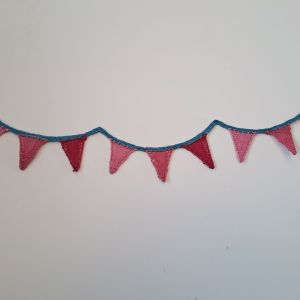 Miniature curved bunting made of lace. The nine pennants are in three shades of dark pink