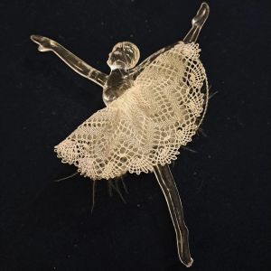 Clear plastic ballerinas in arabesque and pirouette positions with white lace skirts, with gold or silver detail